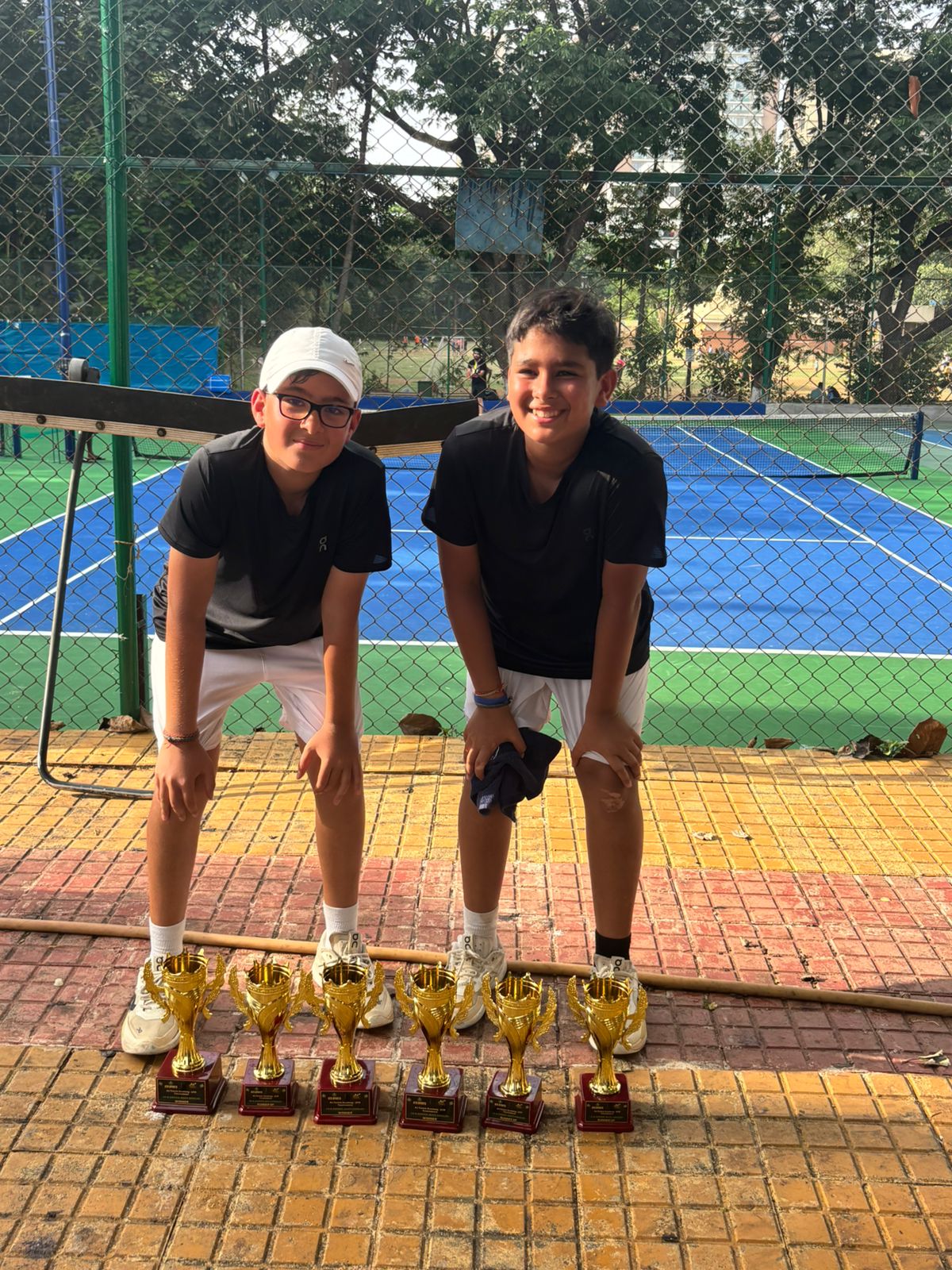 Junior doubles winners with trophies